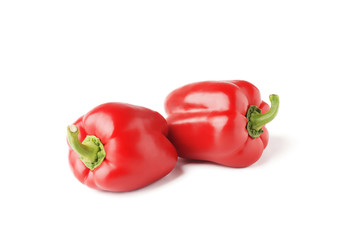 Two red Bell peppers isolated on white background.