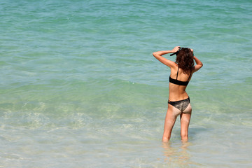 Tourists teenage girl enjoying to use the snorkel on the beach.
