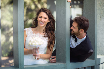 Playful bride and groom couple laugh and smile together, happy and in love wedding day