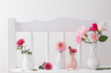 pink roses on vintage wooden white shelf