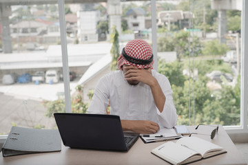Businessman Arab men sitting stressed after working for long hours on laptop. Concept of emotional distress,  Business strain