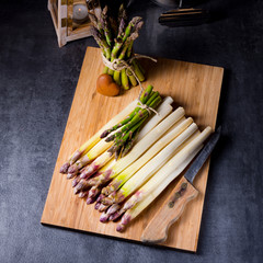 white and green asparagus on kitchen board