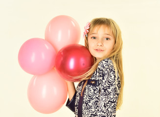 Fototapeta na wymiar Small girl child with party balloons, celebration. Beauty and fashion, punchy pastels. Little girl with hairstyle hold balloons. Kid with balloons, birthday. Birthday, happiness, childhood, look.