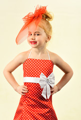 Retro look, hairdresser, makeup, pin up. Child girl in stylish glamour elegant dress. Retro girl, fashion model, beauty. Fashion and beauty, pinup style, childhood. Little girl in vintage dress, prom.