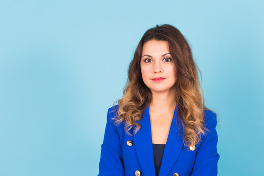 Smiling Young Business Woman Portrait On Blue Background.