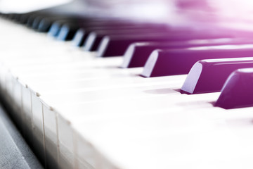 Side view of piano keys. Close-up of piano keys. Close frontal view. Piano keyboard with selective focus. Diagonal view. Piano keyboard perspective. Soft ligting