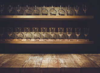 Empty the top of wooden table with blurred counter bar and glass Background