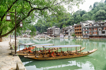 Fototapeta na wymiar Parked wooden tourist boats on the Tuojiang River, Fenghuang