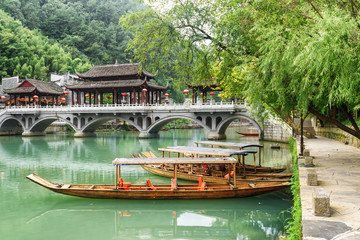 Parked wooden boats on the Tuojiang River, Fenghuang, China