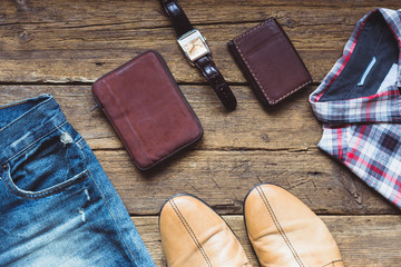 Men's clothes and accessories on wooden background. Top view - Powered by Adobe