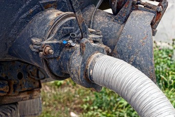 hose from car in the sewer on the street