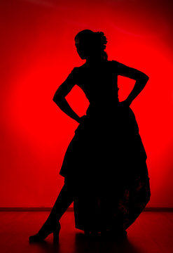silhouette of spanish girl flamenco dancer on a red background