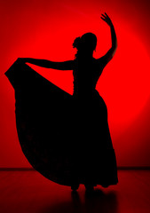 silhouette of spanish girl flamenco dancer on a red background