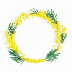 Flowers composition. Wreath made of mimosa flowers on white background. Flat lay, top view, copy space, square