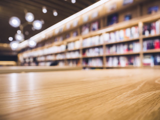 Table top Counter with Blurred Bookshelf Library Background - obrazy, fototapety, plakaty