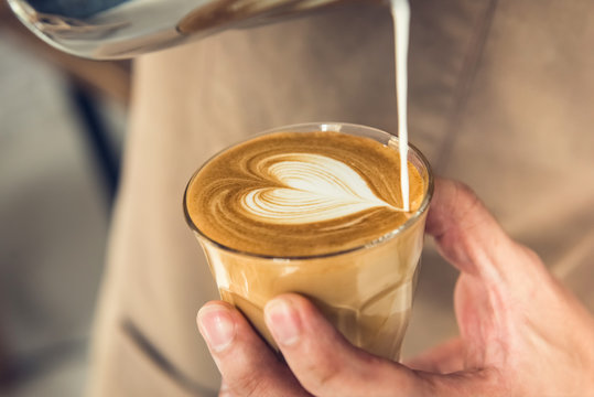 Barista making heart shape latte art coffee