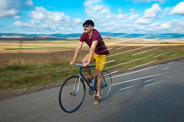Fototapeta na wymiar Casual cyclist riding bicycle very fast