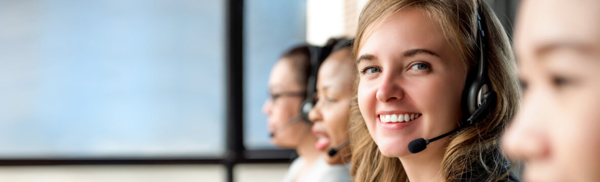 Beautiful caucasian woman working in call center with international colleagues
