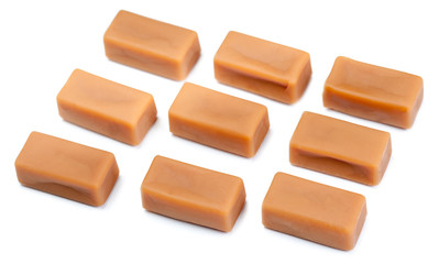 Toffee caramel candies chunks  close-up isolated on white background