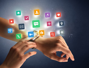 Female hand wearing smartwatch with app icons