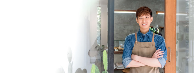Young entrepreneur Asian man at front door of his own cafe
