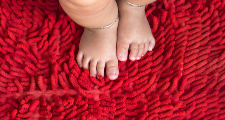 Baby feet on red carpet