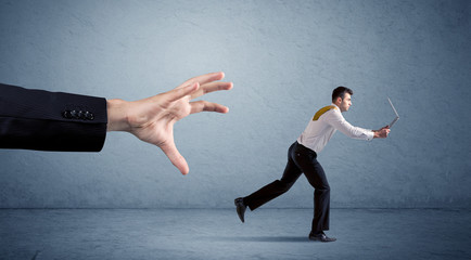 Businessman running from hand