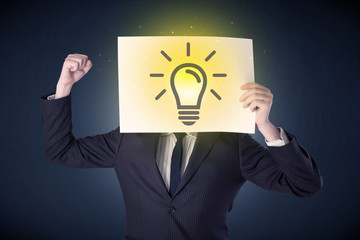 Businessman holding paper with lightbulb