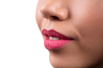 Naklejka premium Closeup, macro photo of smiling woman on white isolate background. Pink lipstick on the lips.