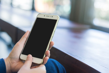 female use cell phones blurred images in coffee shop like the background.