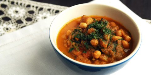 Simple vegetable soup. European cuisine. Chickpeas, potato and carrot. Organic food. Vegan dish. Vegetarian lunch. Wide photo.