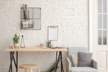 Desk with stationery in the white interior Loft workspace