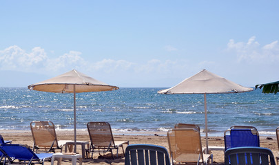 Umbrellas and loungers on the beach of the sandy beach of the Caribbean islands, in the background the sea