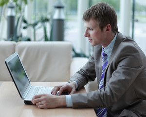 Young employee looking at computer monitor during working day