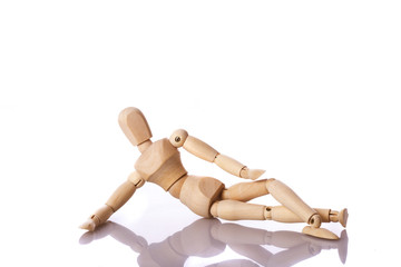 Wooden mannequin lying down
