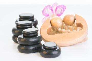 Fototapeta na wymiar Spa treatment with hot stones, massage roller and cellulite massager