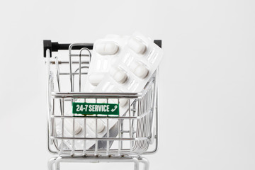 Pills in a mini shopping cart.