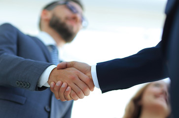 Successful business people handshaking after good deal.