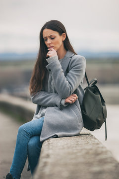 Young lonely and worried woman is sitting and thinking.