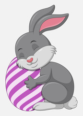 Fototapeta premium Cute grey Easter Bunny hugged egg decorated isolated on a white background