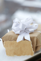 Present in kraft paper wrapping in the snow.