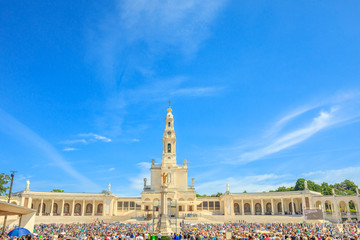 Tourists, faithful and pilgrims in the square of the Sanctuary of Fatima in Portugal for the 100th anniversary of the apparitions of the Virgin Mary. Copy space.
