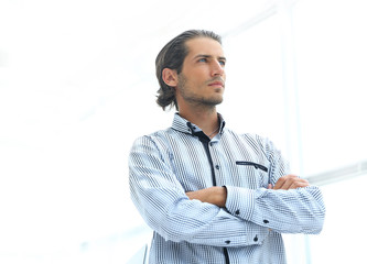 serious businessman on a background of bright office.