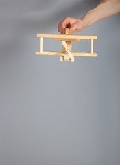 Woodenmade airplane on a gray background.