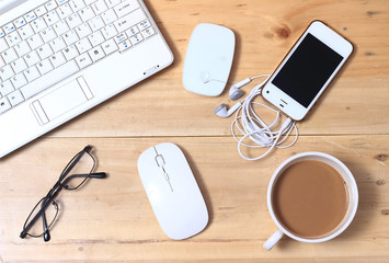White Netbook, Modem, Earphone, Smartphone, Eyeglass, Coffee, Wireless Mouse at Wooden Desk, Flat Lays or Top View
