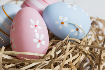 Obraz na płótnie Canvas Hand painted Easter eggs on a hay