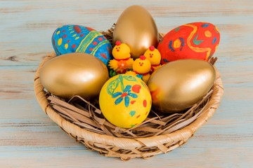 Easter eggs in a basket with yellow baby chicken Easter concept