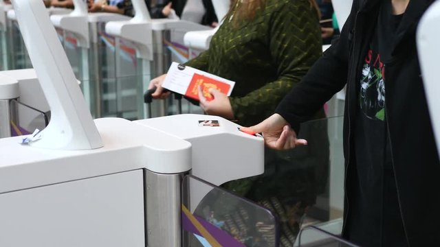 Passenger At Automated Customs Clearance Scanning Fingerprint In Airport.