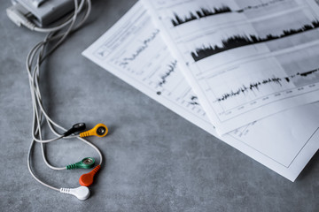 Holter monitoring device on gray background.