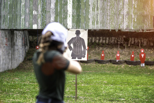 Target practice shooting in aim of woman shooting riffle,  arm and weapon martial art for woman